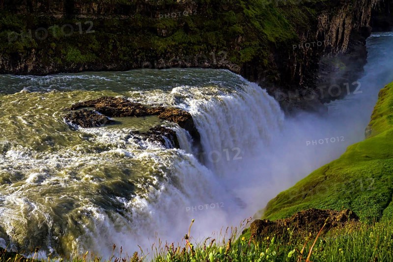Gullfoss Golden Falls - the most beautiful waterfall in Iceland, on the Hvita River. Above the waterfall there is a constant haze of water. The concept of active, extreme, and photo tourism