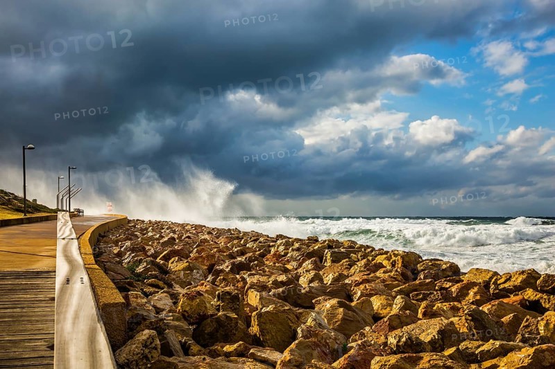 The storm in the Mediterranean Sea. Huge foaming waves beating against the shore. New Quay in the Old Jaffa, Israel