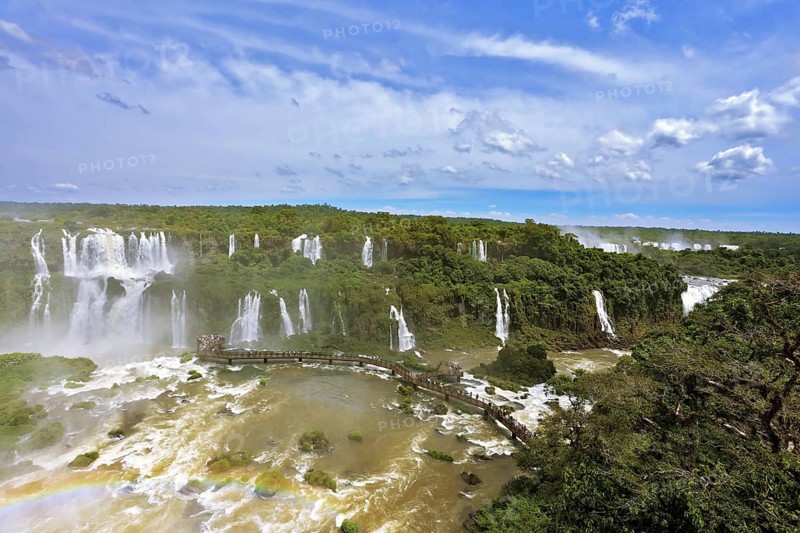Turbid yellow-brown waves flow down. Raging and roaring water in the Brazilian side of the Iguazu Falls