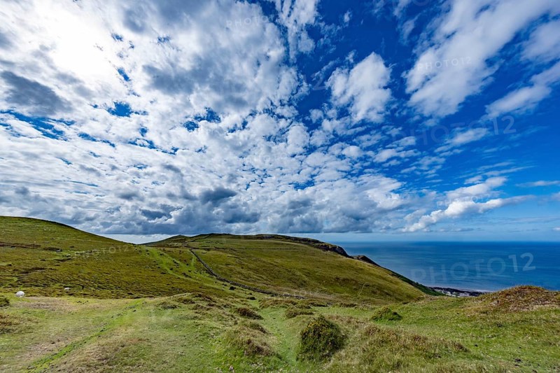 Vast rolling countryside with green meadows and sea views on the edge of Snowdonia National Park, Penmaenmawr, Dwygyfylchi, Caernarfonshire, Conwy County Borough, Wales, United Kingdom