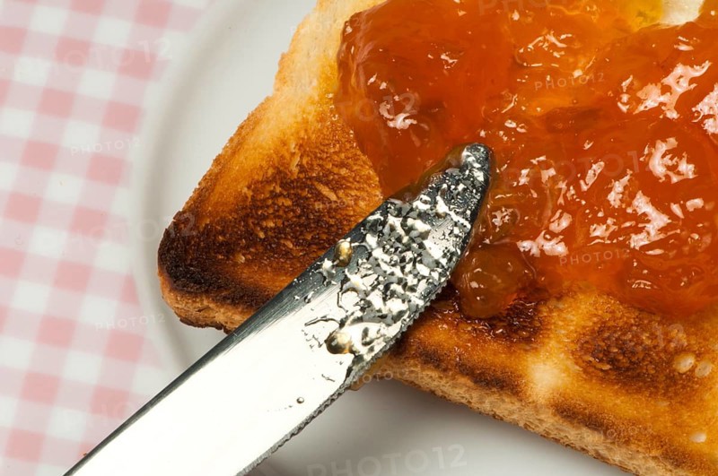 Spread jam on bread with knife