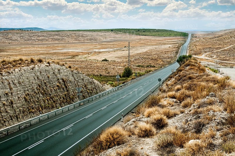 Asphalt road and white line marking. Close up low viewpoint