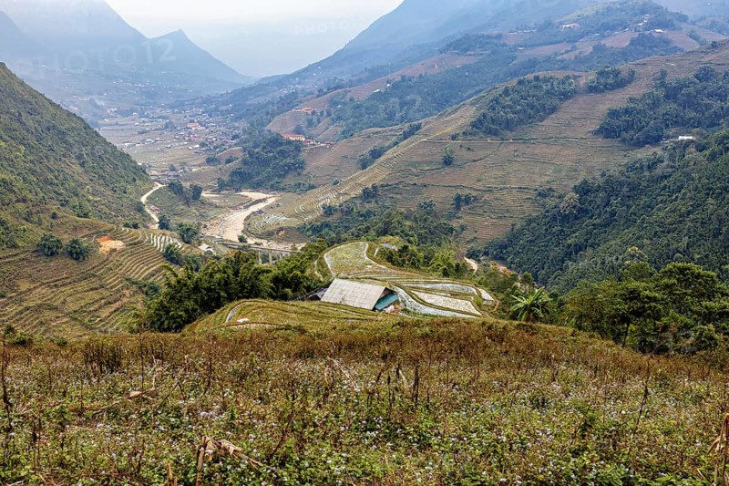 An impressive landscape with green valleys, hills and a meandering river, farms in the rice paddies near Sa Pa in Vietnam