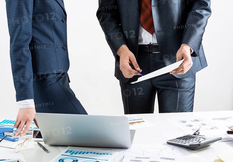 Corporate teamwork concept with businessman. Business people meeting in conference room. Idea presentation and analyze. Office desk with financial charts and laptop. Collaboration and conversation