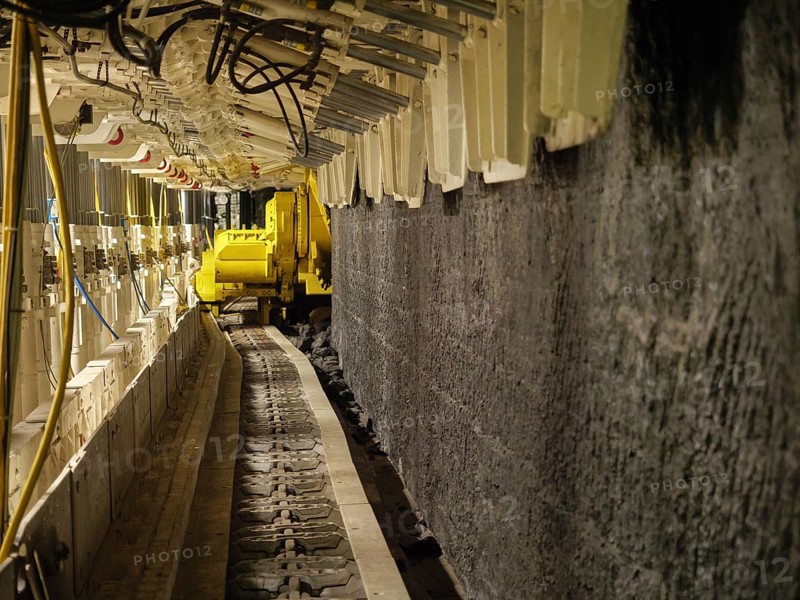 Conveyor belt in tunnel with yellow machine, Bochum, North Rhine-Westphalia, Germany