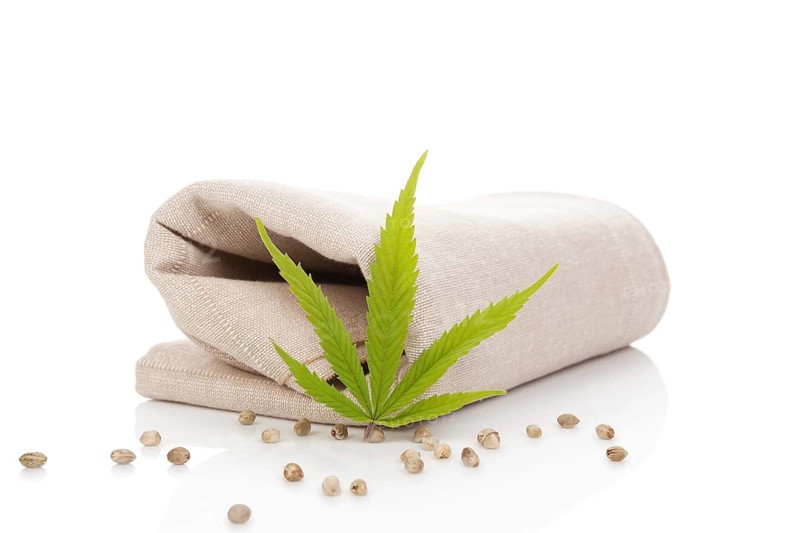 Hemp cloth production, cloth with cannabis leaf and seeds, isolated on white background