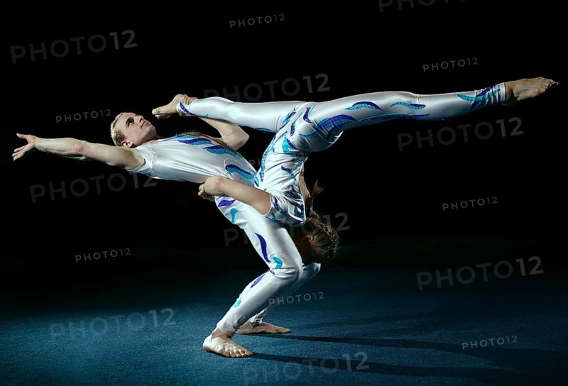 Circus artists perform different tricks. Gym split
