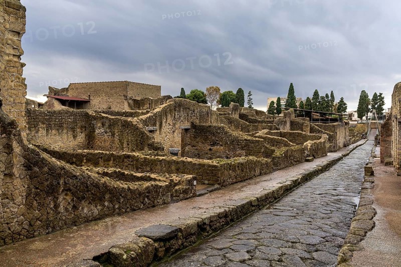 Ercolano, Italy, 25 November, 2023: typical city street and houses in the ancient Roman town of Herculaneum