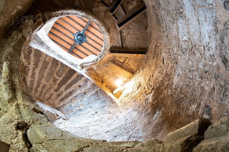 Ancient stairs of snail constructed in stone illuminated by the light of the Sun. Priego de cordoba, Andalucia. Spain