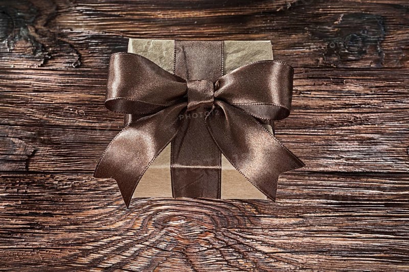 Brown packed gift box on vintage board