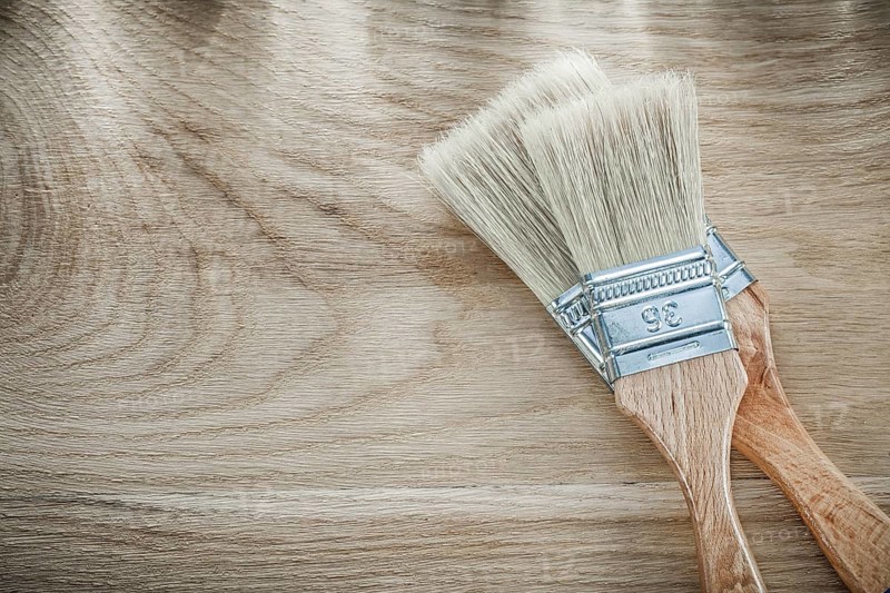 Set of paint brushes on wood board directly above