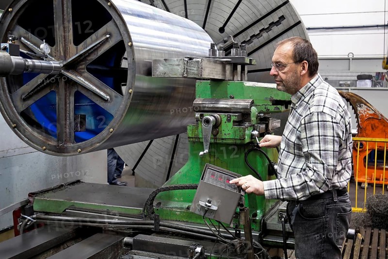 An older employee in the metal industry works on a CNC milling machine, Senior, 65, years, toolmaker, occupation, professions, metal industry Vienna, Austria