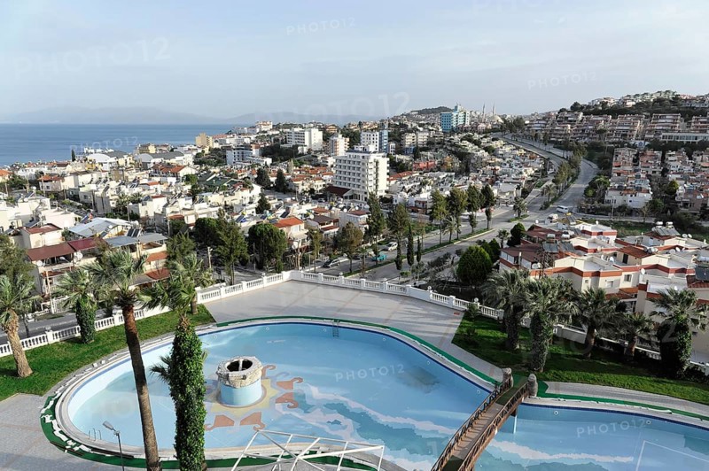 On the way to Ephesus, Lycia, view of urban landscape with swimming pool and palm trees, surrounded by buildings, Antalya Province, Turkey