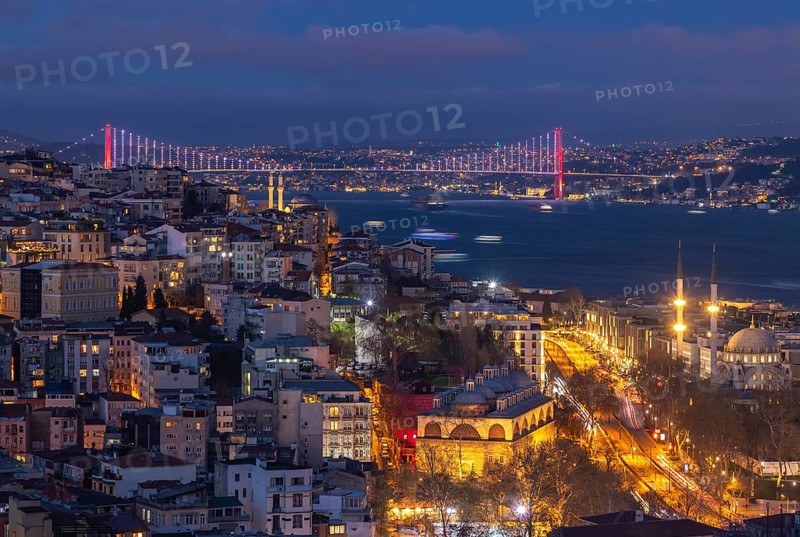 A picture of the buildings of the Beyoglu district and the Bosphorus Bridge at night