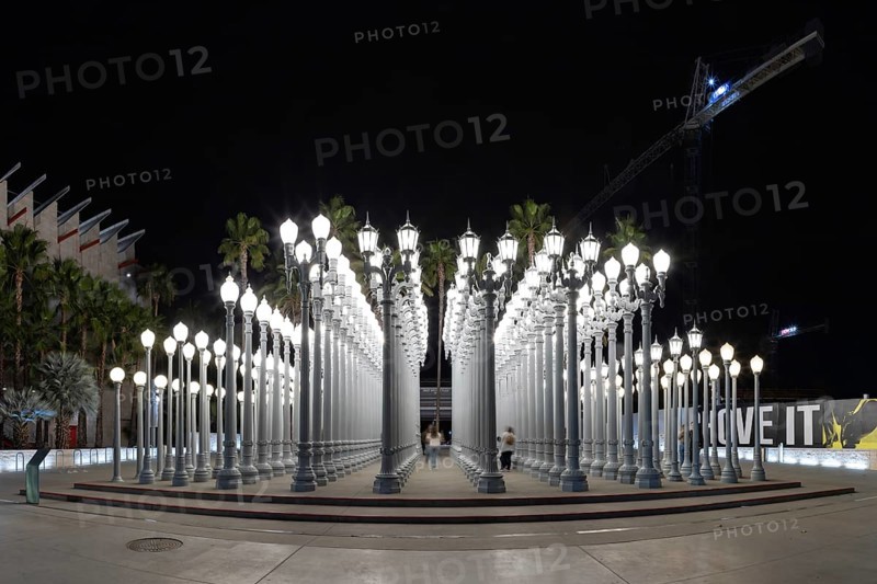 A picture of Urban Light, a public art designed by Chris Burden and unveiled in 2008, next to the Los Angeles County Museum of Art, at night