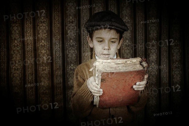 Child with red vintage book. Vintage clothes and hat