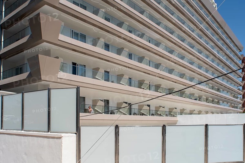 Woman sunbathing on the balcony of Hotel Helios in Benidorm, Alicante province, Spain