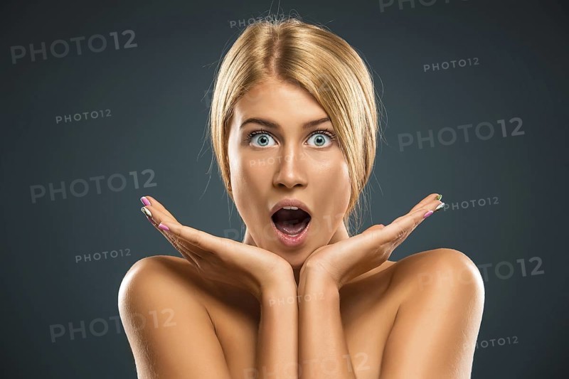Portrait beautiful blond woman with blue eyes stared into the camera - isolated azure background