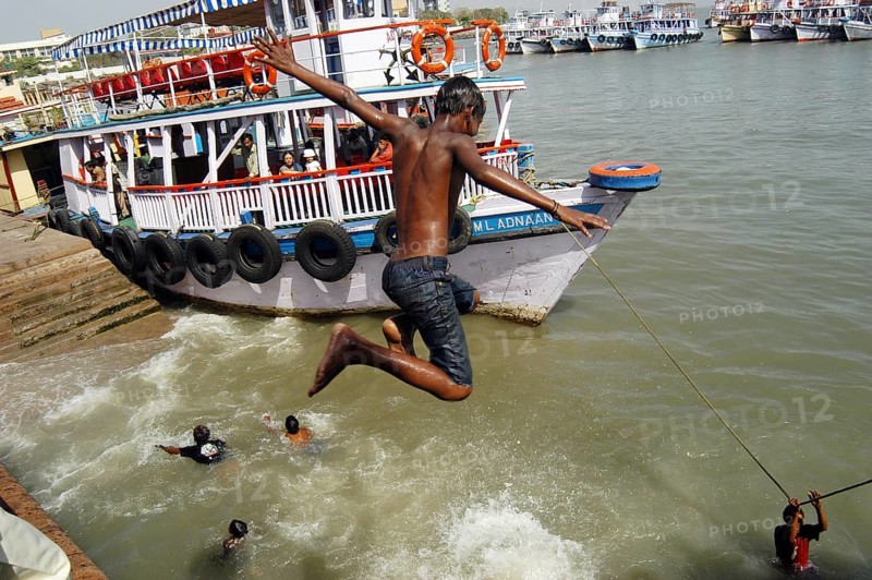 Children jumping and swimming into the Arabian Sea at Gateway of India, Bombay now Mumbai, Maharashtra, India