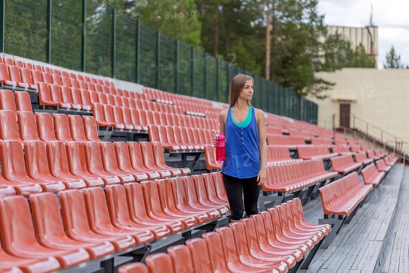 Girl with a bottle of pink at the stadium