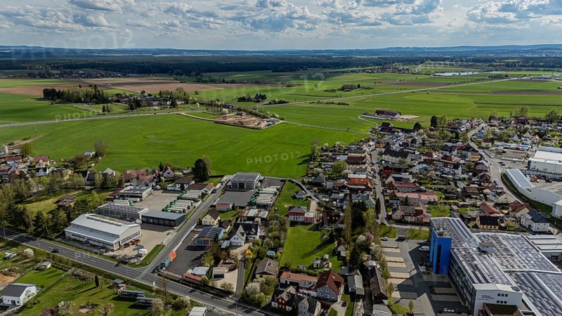 Aerial view of a village with surrounding fields and country road under a cloudy sky, Mitterteich, Upper Palatinate, Bavaria, Germany