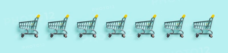 Shopping cart in row on blue background. Minimalism style. Toy trolley for supermarket. Top view or flat lay. Sale, discount, shopaholism concept. Consumer society trend