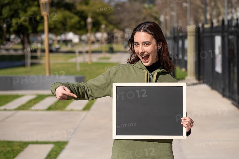 Woman holding a black poster without text. Business template concept