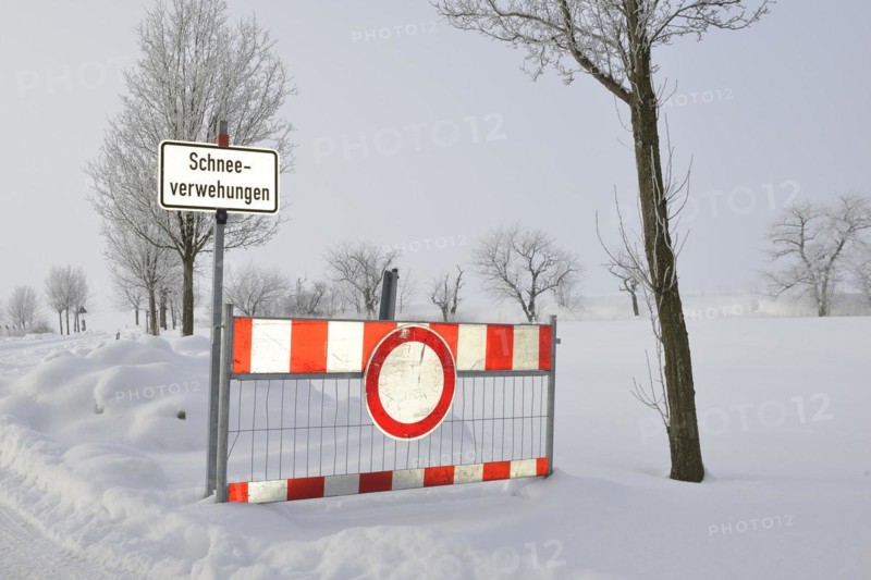Road blockage through snow drifts. Blocked road