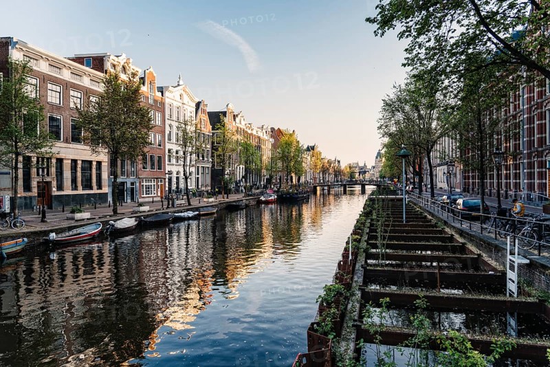 Amsterdam, Netherlands, May 5, 2022: Old typical Amsterdam houses in Red Light District. De Wallen is the famous red-light district in Amsterdam. It consists of a network of alleys containing one-room cabins rented by prostitutes