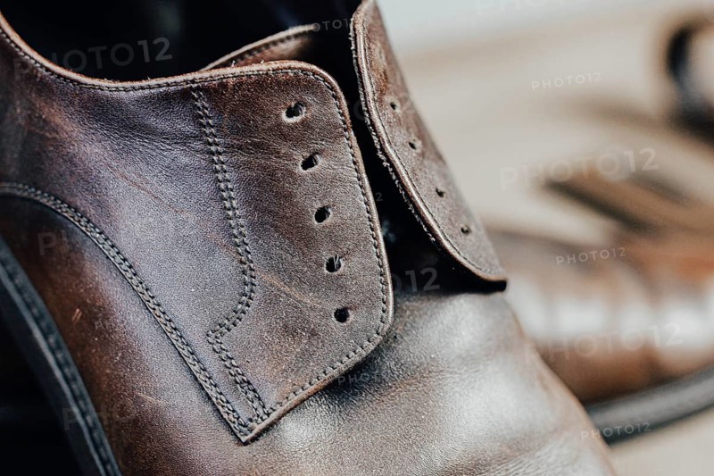 Close-up view of a brown leather shoe showcasing texture and craftsmanship