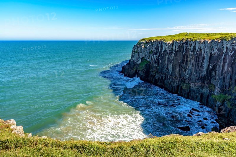 Guarita stone in the city of Torres in Rio Grande do Sul with its cliffs ending in the sea with waves and horizon