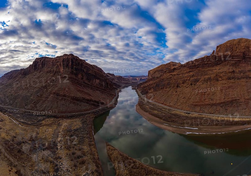 Colorado River and Red Sandstone Mountains on Cloudy Morning. Sky Reflection in Water. Grand County, Utah, USA. Aerial View