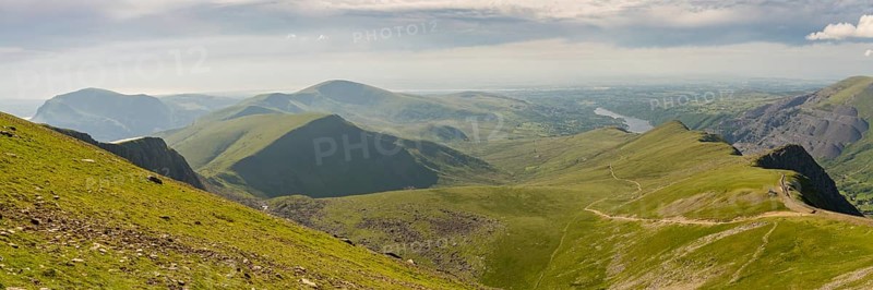 Walking down from Mount Snowdon on the Llanberis Path, Snowdonia, Gwynedd, Wales, UK, looking north towards the Clogwyn station, Llyn Peris and Llanberis