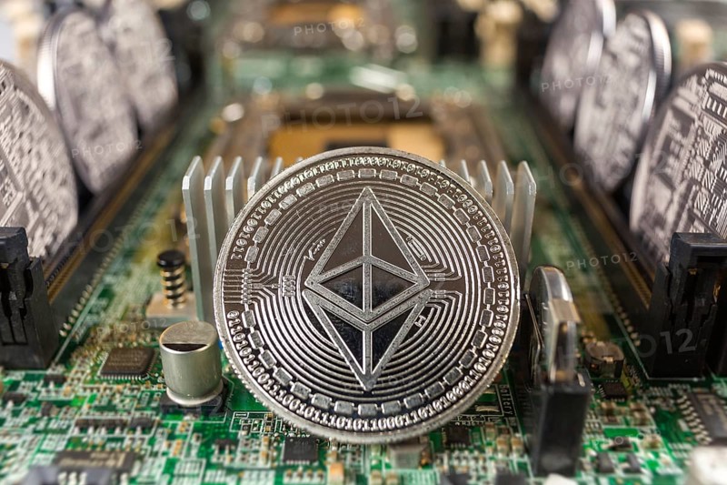 Ethereum coin close-up on a computer circuit motherboard as a blockchain technology payment network. Digital cryptocurrency concept and mining