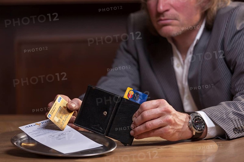 Man in suit pays the bill with credit card, Mindelheim, Bavaria, Germany