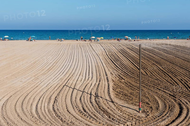 Alicante, Spain, October 13, 2023: Furrows in the sand from sand cleaning raking in the beach of San Juan