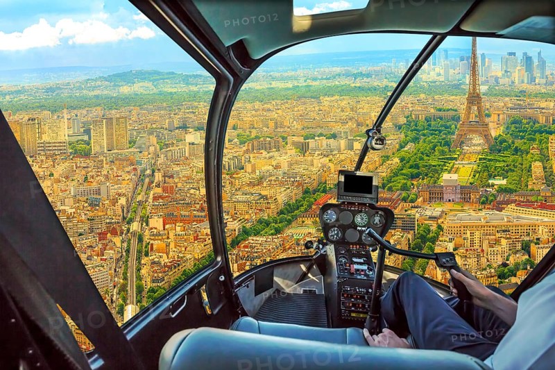Helicopter cockpit aerial view of Tour Eiffel in Paris, French capital, Europe. Scenic flight above Paris skyline and cityscape, France