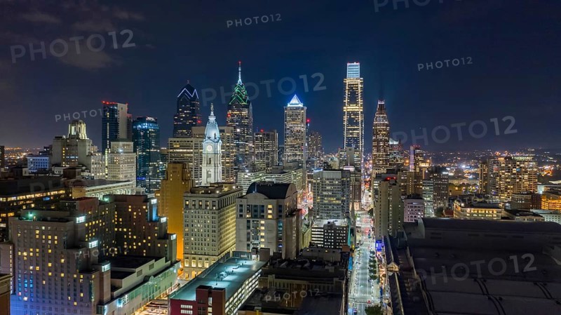 Aerial view night sky over the neighborhoods and streets of Philadelphia PA USA