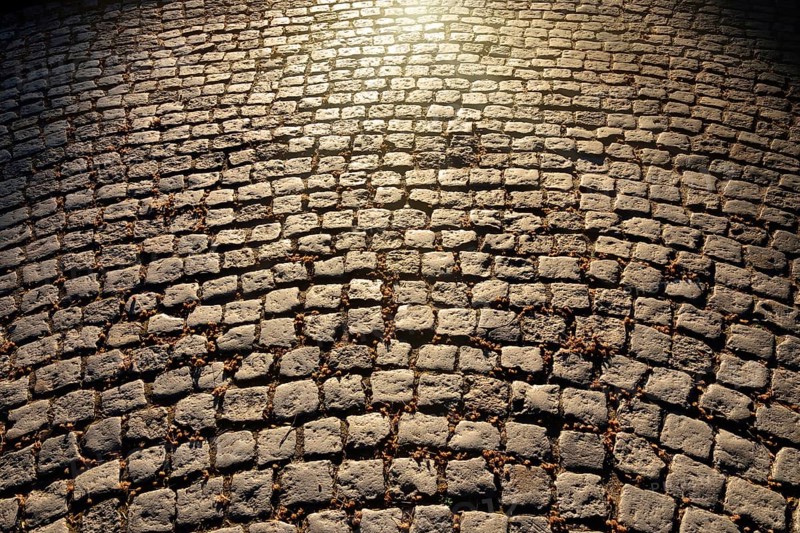 Gloomy old cobblestone pavement. Beautiful natural background