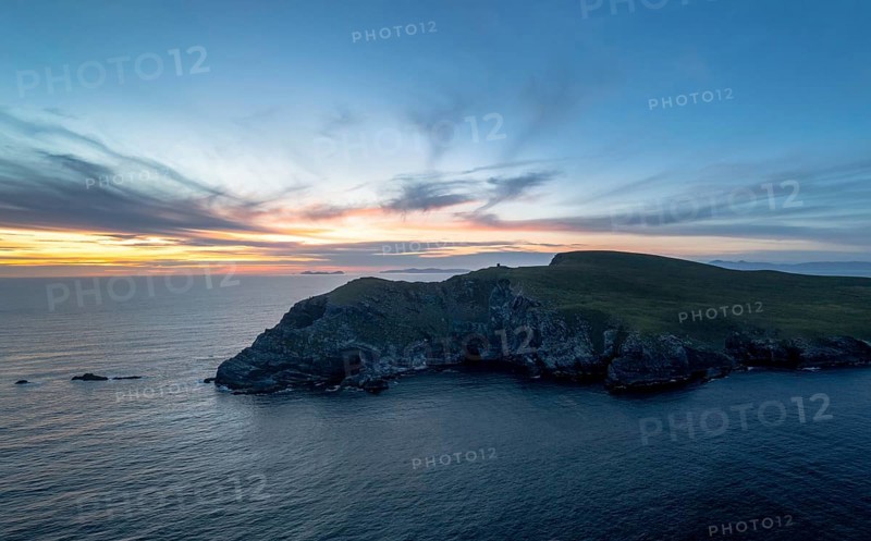 Sunset over the Atlantic Ocean and the cliffs of Bray Head on Valentia Island in County Kerry of western Ireland