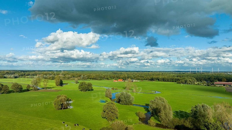 Aerial view of a beautiful green landscape with a small river flowing through. It is in the eastern part of the Netherlands