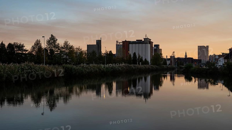 Wilsele, Flemish Brabant, Belgium, Reflection of industrial buildings in the canal during sunset