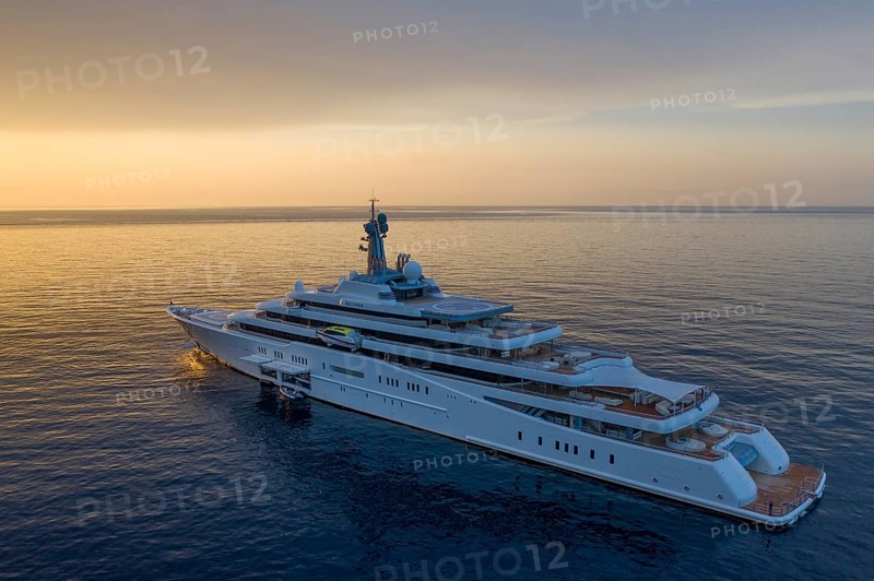 Aerial view 162, 5 metre long motor yacht ECLIPSE, delivered in 2010 by the Hamburg shipyard Blohm & Voss to the Russian oligarch Roman Abramovich, designer Terence Disdale, until 2013 the largest yacht in the world, at anchor at sunrise in the bay of Beaulieu-sur-Mer near Cap Ferrat, French Riviera, France, Mediterranean Sea