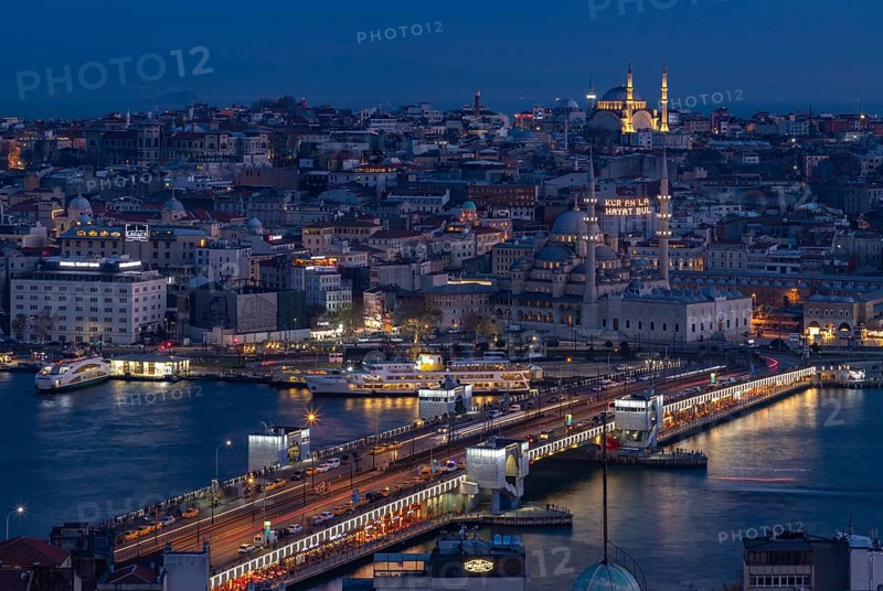 A picture of the Galata Bridge, with the New Mosque and the Nuruosmaniye Mosque, at night
