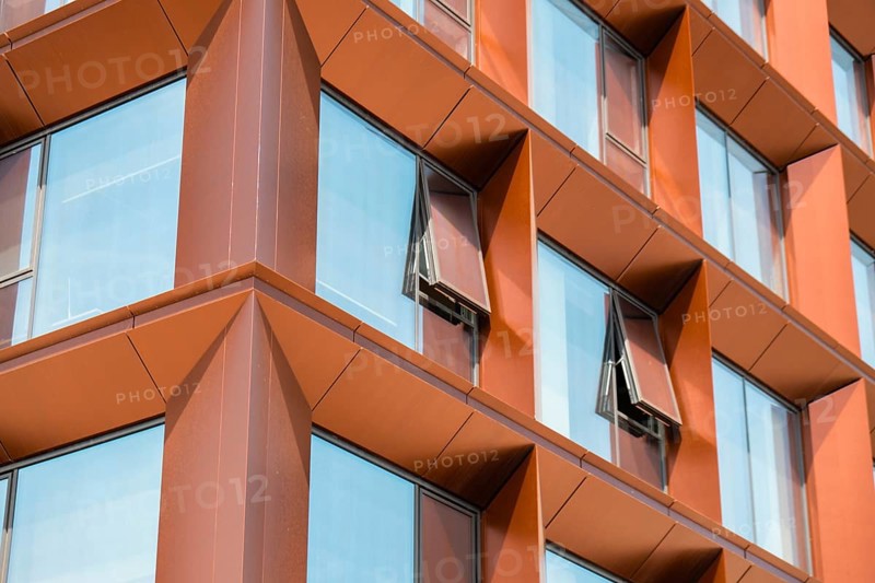 Modern office building exterior with glass facade on clear sky background. Transparent glass wall of office building with yellow decoration. Abstract Structure Element of facade of modern European building Commercial office buildings. modern business architecture Architecture minimal concept. Visual art. Conceptual photography