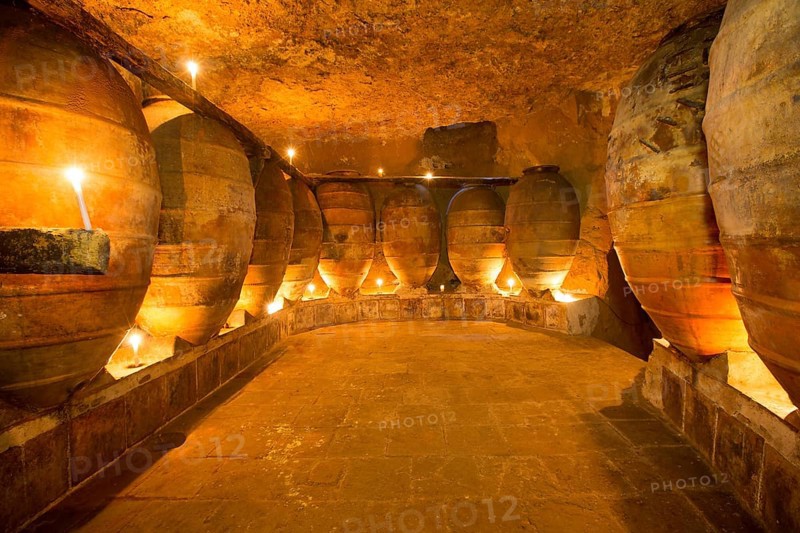 Antique winery in Spain with clay vessels terracotta amphora pots Mediterranean tradition with candlelight