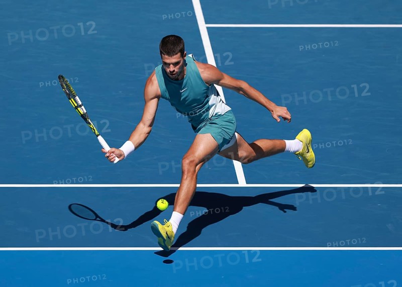 Spanish tennis player Carlos Alcaraz (ESP) playing forehand shot at Australian Open 2025 tournament, Melbourne Park, Melbourne, Victoria, Australia