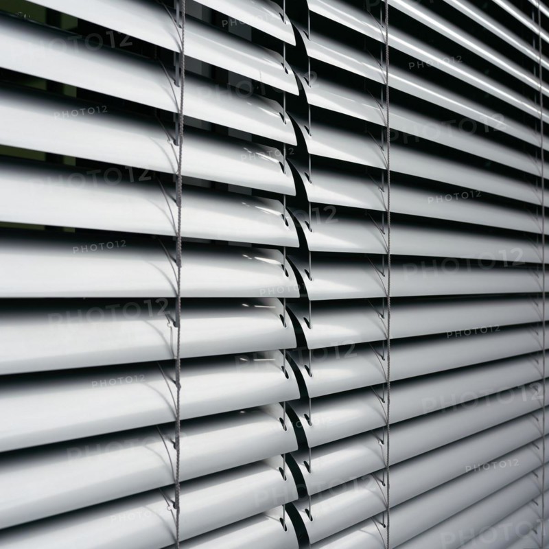 Venetian blind as sun protection on the window of a B