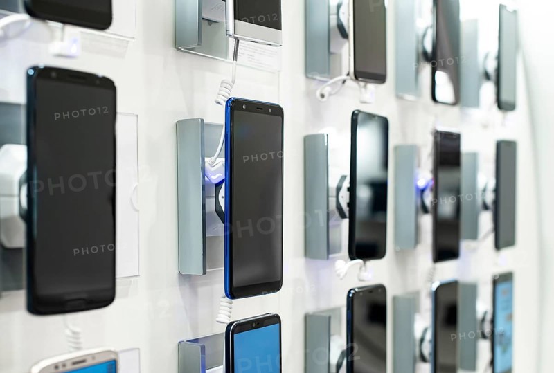 Smartphones on shelf in the store. Concept for communications and technology. Buying mobile phone in technology shop