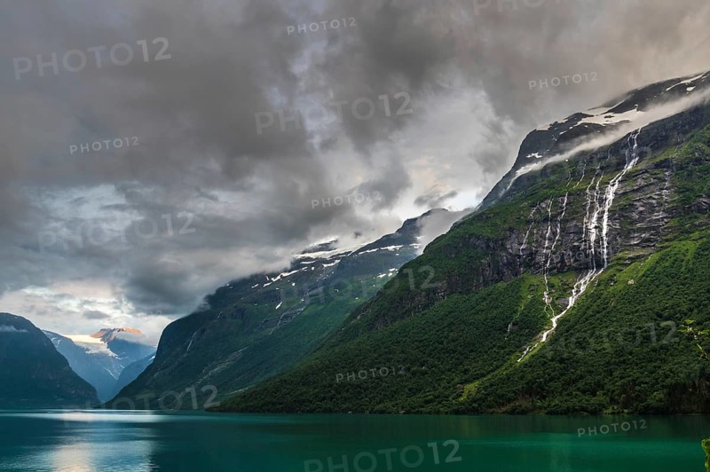 The Kjenndalsbreen is part of the Jostedalsbreen, one of the largest glaciers in Norway, and forms an impressive mountain landscape with a beautiful lake in Sande. The glacier Kjenndalsbreen with a lake in Norway is a beautiful place to travel to in summertime